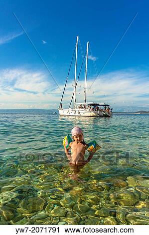 Girl in Vaja bay near Racisce on Korcula island, Croatia. View Large Photo Image Stock Image - Girl in Vaja bay near Racisce on Korcula island, Croatia.. Fotosearch