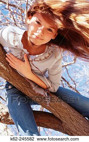 Girl inside down in a tree View Large Photo Image Stock Image - Girl inside down in a tree. Fotosearch