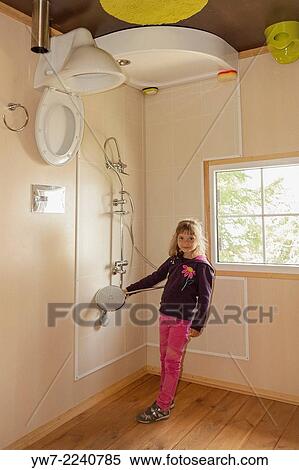 Stock Photography - Girl inside upside-down house in Jastrzebia G? ra, Poland.. Fotosearch