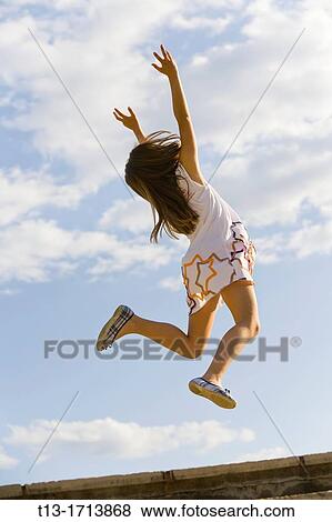 Girl is jumping View Large Photo Image Stock Photo - Girl is jumping. Fotosearch