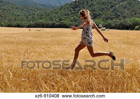 girl jumping in field View Large Photo Image Stock Photo - girl jumping in field. Fotosearch