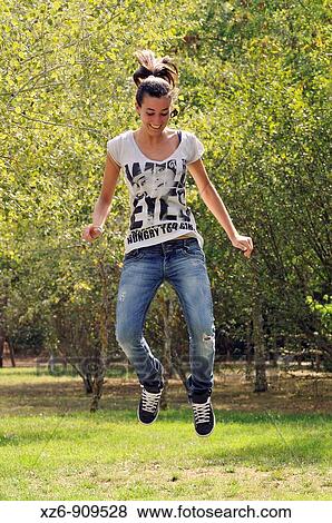 girl jumping in the park View Large Photo Image Stock Photo - girl jumping in the park. Fotosearch