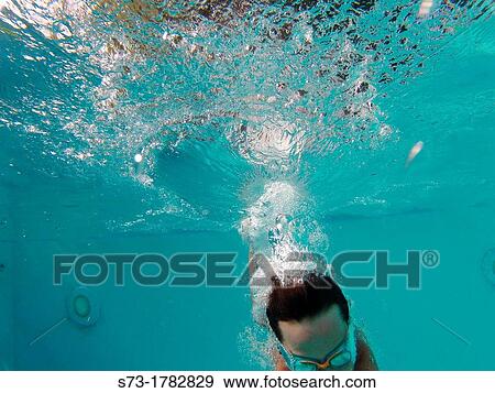 Stock Photo - Girl jumping into swimming pool. Fotosearch