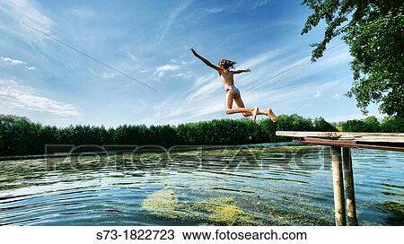 Girl jumping to the Lake Avral, Kirillovka, Samara Region, Russian Federation View Large Photo Image Stock Image - Girl jumping to the Lake Avral, Kirillovka, Samara Region, Russian Federation. Fotosearch