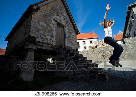 Girl junping near horreo, granary built on pillars typical in the north-west of Spain View Large Photo Image Stock Photograph - Girl junping near horreo, granary built on pillars typical in the north-west of Spain. Fotosearch