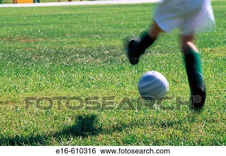 Stock Photograph - Girl kicking soccer ball. Fotosearch