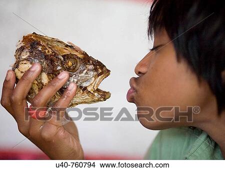 Girl kissing cooked fish View Large Photo Image Picture - Girl kissing cooked fish. Fotosearch