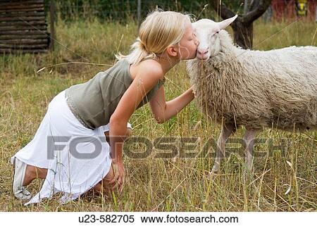 Girl kissing her ewe View Large Photo Image Stock Photography - Girl kissing her ewe. Fotosearch