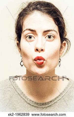Stock Photo - girl kissing like a fish. Fotosearch