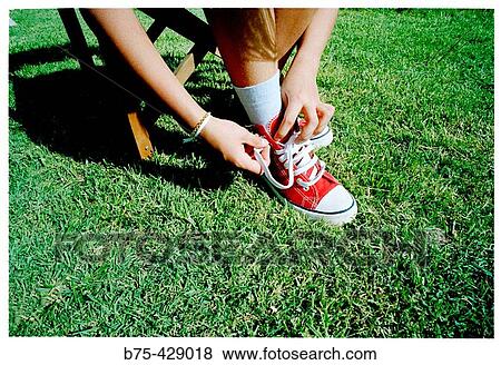 Girl lacing up shoes. View Large Photo Image Stock Photo - Girl lacing up shoes.. Fotosearch