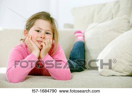 Girl laying on coach View Large Photo Image Stock Image - Girl laying on coach. Fotosearch