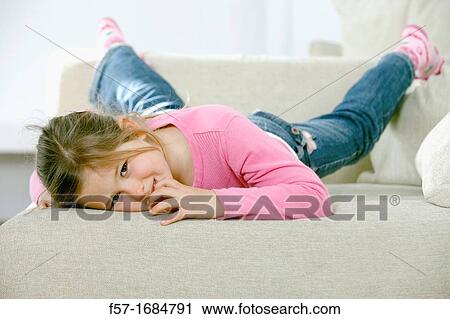 Girl laying on coach View Large Photo Image Stock Image - Girl laying on coach. Fotosearch