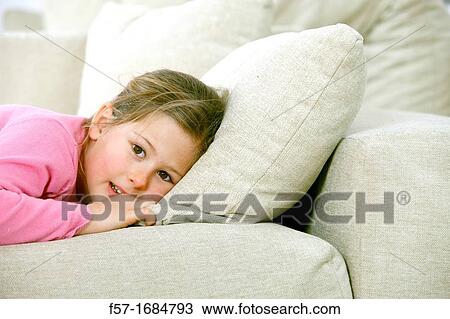 Girl laying on coach View Large Photo Image Stock Image - Girl laying on coach. Fotosearch