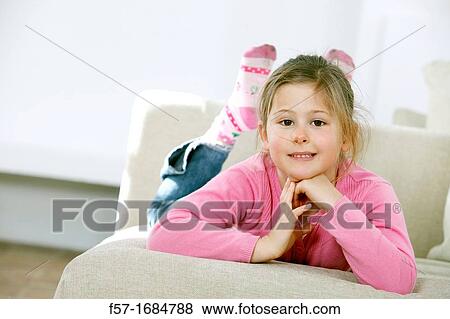 Girl laying on coach View Large Photo Image Stock Photo - Girl laying on coach. Fotosearch