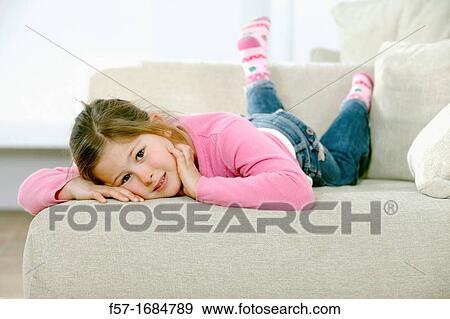Girl laying on coach View Large Photo Image Stock Photo - Girl laying on coach. Fotosearch