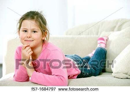 Girl laying on coach View Large Photo Image Stock Photo - Girl laying on coach. Fotosearch