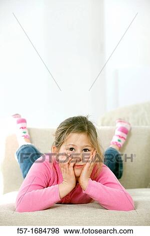 Girl laying on coach View Large Photo Image Stock Photo - Girl laying on coach. Fotosearch