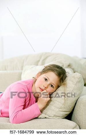 Girl laying on coach View Large Photo Image Stock Photo - Girl laying on coach. Fotosearch