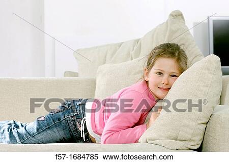 Girl laying on coach View Large Photo Image Stock Photography - Girl laying on coach. Fotosearch