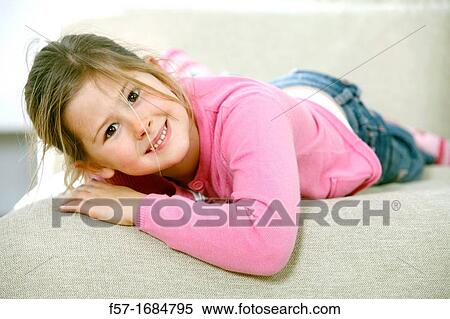 Girl laying on coach View Large Photo Image Stock Photography - Girl laying on coach. Fotosearch