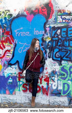 Girl leaned against colorful John Lennon wall in Prague. View Large Photo Image Stock Image - Girl leaned against colorful John Lennon wall in Prague.. Fotosearch