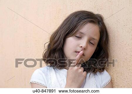 Girl leaning head against wall View Large Photo Image Stock Image - Girl leaning head against wall. Fotosearch