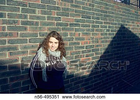 Girl leaning on brick wall View Large Photo Image Stock Image - Girl leaning on brick wall. Fotosearch