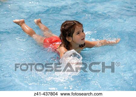 Girl learns to swim in swimmingpool View Large Photo Image Picture - Girl learns to swim in swimmingpool. Fotosearch