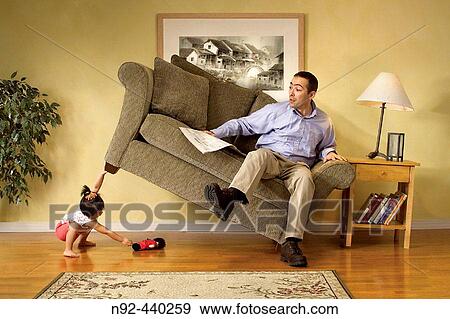 Girl lifting sofa. View Large Photo Image Stock Photo - Girl lifting sofa.. Fotosearch