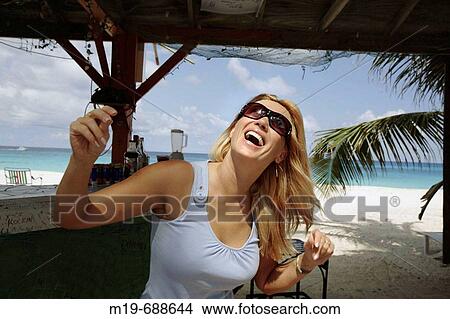 Girl listening and dancing to music at a tropical beach View Large Photo Image Picture - Girl listening and dancing to music at a tropical beach. Fotosearch