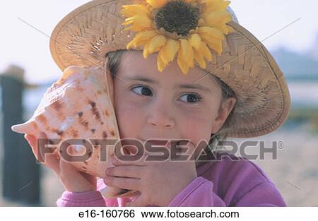 Girl listening to conch shell View Large Photo Image Stock Photograph - Girl listening to conch shell. Fotosearch