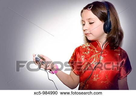 Stock Image - Girl listening to music. Fotosearch