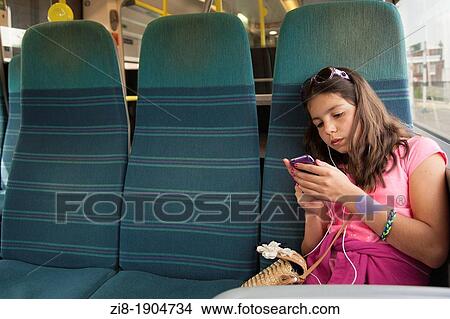 Girl listens to music on the train View Large Photo Image Picture - Girl listens to music on the train. Fotosearch