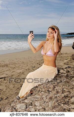 Stock Photograph - Girl look the mirror for check her beauty.. Fotosearch