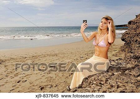 Stock Photography - Girl look the mirror for check her beauty.. Fotosearch