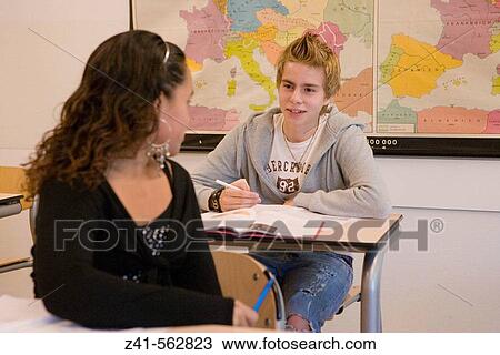 Girl looking at a boy in the classroom View Large Photo Image Stock Image - Girl looking at a boy in the classroom. Fotosearch