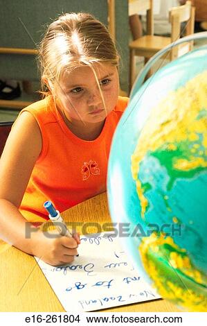 Girl looking at globe View Large Photo Image Picture - Girl looking at globe. Fotosearch