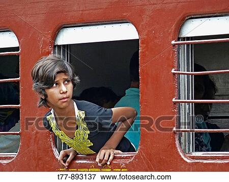 Girl looking outside a train emergency exit window View Large Photo Image Stock Photo - Girl looking outside a train emergency exit window. Fotosearch