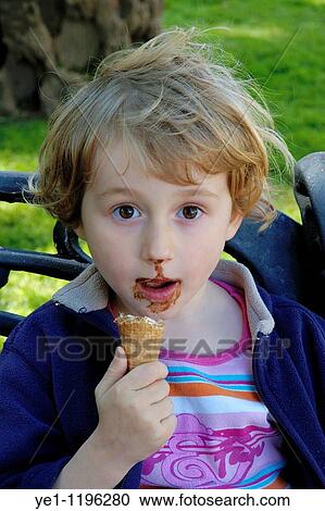 Girl looking surprised after being interrupted while eating an ice cream. View Large Photo Image Stock Image - Girl looking surprised after being interrupted while eating an ice cream.. Fotosearch