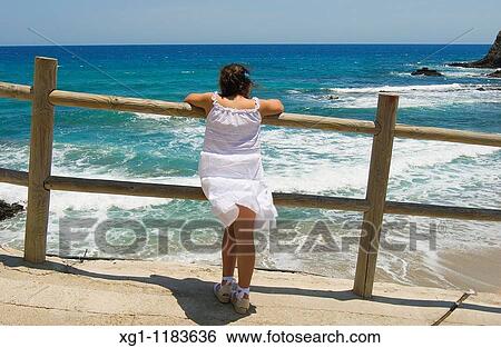 GIRL LOOKING THE SEA, ISLETA DEL MORO, CABO DE GATA NATURAL PARK, ALMERIA, ANDALUCIA, SPAIN View Large Photo Image Stock Photograph - GIRL LOOKING THE SEA, ISLETA DEL MORO, CABO DE GATA NATURAL PARK, ALMERIA, ANDALUCIA, SPAIN. Fotosearch