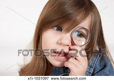 Girl Looking through a magnifying glass View Large Photo Image Stock Photo - Girl Looking through a magnifying glass. Fotosearch
