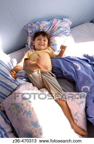 Stock Image - Girl lying in bed. Fotosearch