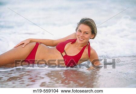 girl lying in the surf View Large Photo Image Picture - girl lying in the surf. Fotosearch