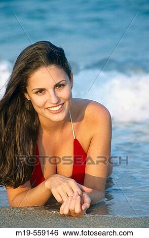 girl lying in the surf View Large Photo Image Stock Photograph - girl lying in the surf. Fotosearch