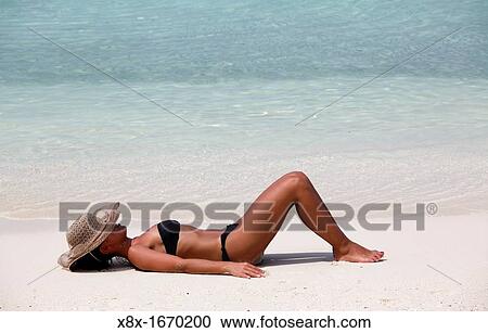 Girl lying on the beach at the seashore, Biyadhoo island, Maldives View Large Photo Image Stock Image - Girl lying on the beach at the seashore, Biyadhoo island, Maldives. Fotosearch