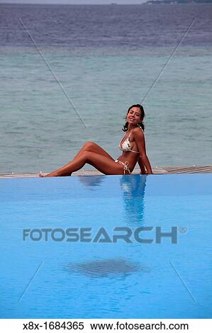 Girl lying on the pool side, Filitheyo island, Maldives View Large Photo Image Stock Photography - Girl lying on the pool side, Filitheyo island, Maldives. Fotosearch
