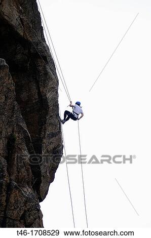 Girl making a mountain rappelling on a rock wall View Large Photo Image Stock Photo - Girl making a mountain rappelling on a rock wall. Fotosearch