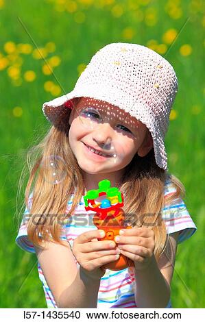 girl making bubbles while standing in blooming field View Large Photo Image Stock Image - girl making bubbles while standing in blooming field. Fotosearch