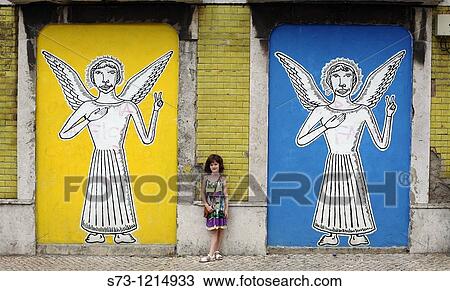 Girl near a wall painting with angels in Lisbon streets, Portugal, Europe View Large Photo Image Stock Image - Girl near a wall painting with angels in Lisbon streets, Portugal, Europe. Fotosearch