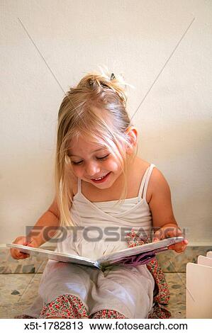 Girl of three reads a book View Large Photo Image Stock Image - Girl of three reads a book. Fotosearch